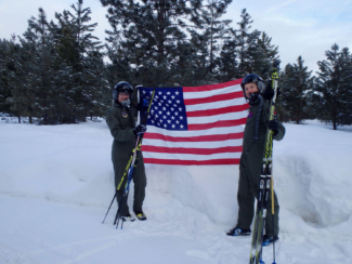 Pete and Pam Fitzsimmons, Team PFFlyers reporting for (race) duty, along with a flag in honor of the start of the Olympics.